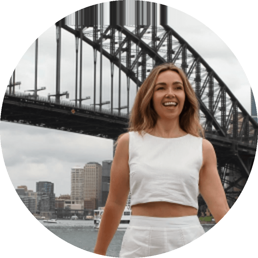 Kirsty McLean laughing in white, the Sydney Harbour Bridge behind her